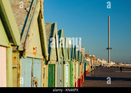 Winter Nachmittag am Strand Hütten direkt an der Meeresküste von Brighton, UK. i360 Tower in der Ferne. Stockfoto