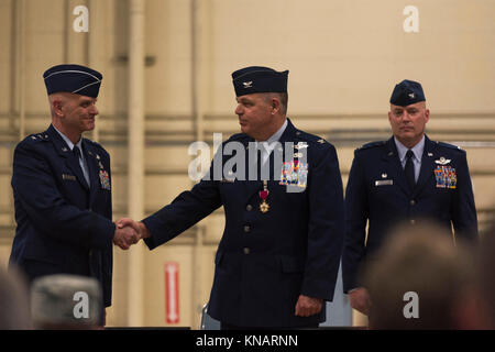 Us Air Force Colonel William Robertson, Mitte, der Kommandant der 182. Airlift Wing, Illinois Air National Guard, erhält einen Händedruck von Generalmajor Ron Paul, der Assistent Adjutant General-Air der Illinois National Guard, während Commander's Anruf in Peoria, Illinois, November 4, 2017. Robertson die Flügel für 13 Jahre geboten, bevor seine Förderung allgemein und Transfer zum Zustand der Zentrale zum brigadier. (U.S. Air National Guard Stockfoto