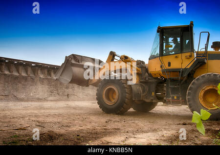 Bagger lasten Kies in den Lkw Stockfoto