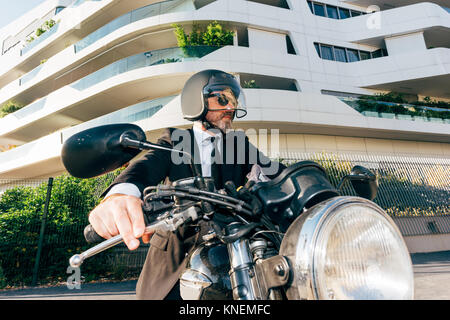 Portrait von Reifen Geschäftsmann im Freien, auf dem Motorrad, Motorrad Helm tragen Stockfoto