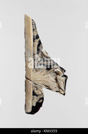 Dieses römische Glaskamäofragment, datiert 1–25 n. Chr., zeigt komplizierte geschnitzte Designs und Handwerkskunst, die oft in Schmuck oder dekorativen Objekten verwendet werden. Stockfoto