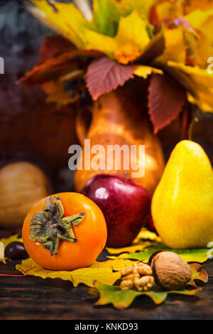 Bunte Herbst noch Leben der Ernte und Walnüsse auf hölzernen Schreibtisch liegend auf Baum Blatt. Mockup für saisonale Angebote und Urlaub Post Card Stockfoto