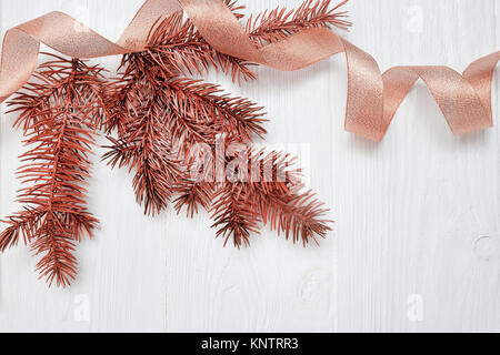 Mockup Christmas tree branch und gold Geschenkband, flatlay auf einem weißen Hintergrund, aus Holz mit Platz für Ihren Text Stockfoto