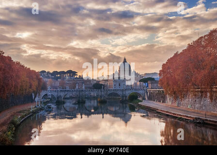 Blätter im Herbst am Ufer des Flusses Tiber in Rom mit dem Hl. Petrus Dome und heilige Engel Bridge bei Sonnenuntergang Stockfoto