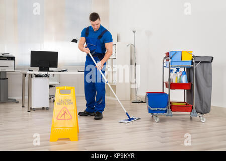 Hausmeister wischen Stock im Büro Stockfoto