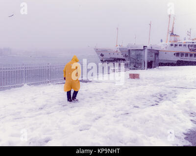 Unbekannter Mann zu Fuß in der Nähe von Karaköy Pier an einem verschneiten Tag im Winter. Istanbul, Türkei, 07. Januar 2017 Stockfoto