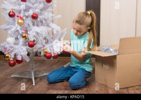 Mädchen schießt Kugeln mit Weihnachtsbaum Stockfoto