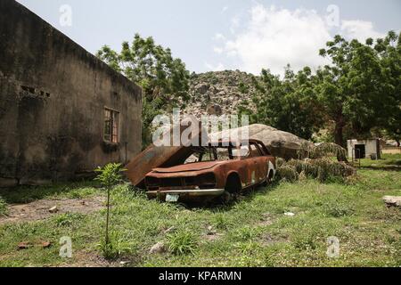 Borno State, Nigeria. 27 Juni, 2017. Eine ausgebrannte Autos liegt in der Nähe ein Massengrab in einem zerstörten Krankenhaus zuvor von Boko Haram militanten verwendet. Credit: Sally Hayden/SOPA/ZUMA Draht/Alamy leben Nachrichten Stockfoto