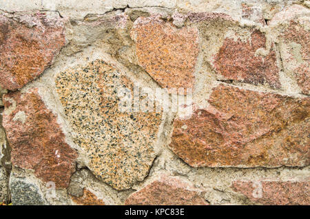 Hintergrund Steinmauern aus rosa Granit, Textur Stockfoto