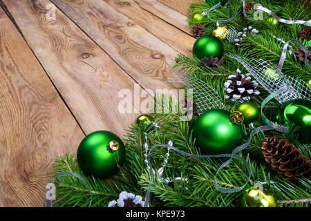 Weihnachtsgirlande mit Tannenzweigen, grün Flitter silber Farbband, Schnee dekoriert Tannenzapfen auf der rustikalen Holzmöbeln Hintergrund Kopie Raum Stockfoto