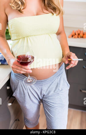 Frau schwanger ist, aber Trinken und Rauchen Stockfoto