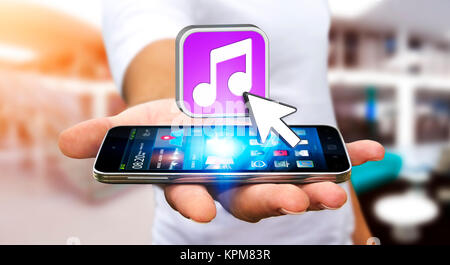 Junger Mann mit modernen Mobiltelefon Musik hören Stockfoto