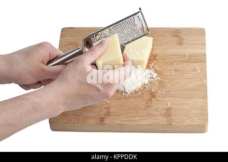 Menschliche Hand Reibe und Parmesan Stockfoto