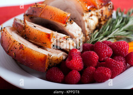 Schweinefleisch mit Himbeeren und Pfeffer auf die weiße Platte. Foto. Stockfoto