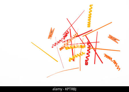 Kleine Dinge Materie, bunten roten und gelben Papier gemischt und hölzerne bemalte Wäscheklammern isoliert auf weißem Hintergrund Stockfoto
