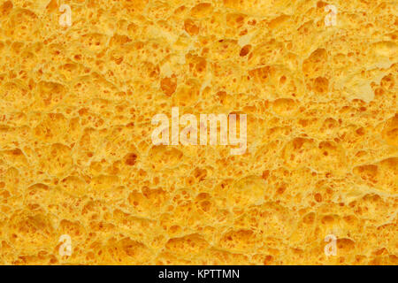 Texturierte Oberfläche des porösen gelben Schwamm close-up. Für den Hintergrund. Stockfoto