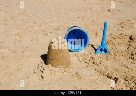 Sandburg, Eimer und Schaufel am Strand Stockfoto