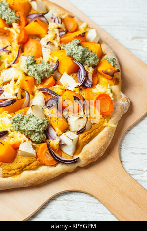 Hausgemachte Pizza mit Winter Squash, Pastinaken, schwarzem Rettich, roten Zwiebeln, veganer Käse und Rettich grünen Pesto. Stockfoto