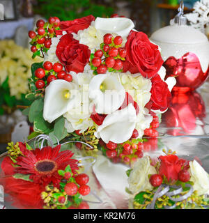 Foto von einem Urlaub in Rot und Weiß Brautstrauß. Calla Lilien, Rosen, Hypericum Beeren, Hortensien und Gerbera dasies sind auch das ganze Jahr verfügbar. Stockfoto