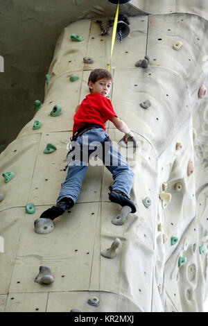 Dieser junge Genossen Klettern auf der Royal Caribbean Liberty of the Seas Kletterwand. Stockfoto