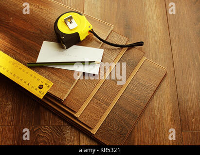 Laminat Dielen und Tools auf Holz- Hintergrund. Verschiedene Tischler Werkzeuge auf dem Laminat. Top View Stockfoto