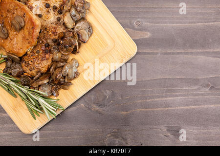 In der Ansicht von oben auf Schweinesteak mit gegrillten Champignons Stockfoto