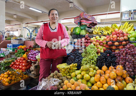 Cuenca Ecuador - einem standbesitzer auf dem Lebensmittelmarkt verkaufen Obst aus ihrem Stall, Markthalle Cuenca, Cuenca, Ecuador Südamerika Stockfoto