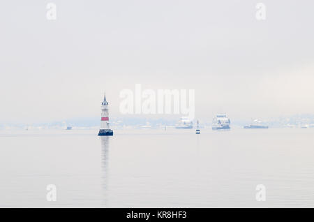 Zwei kleine Fähren in der Route von und nach Oslo, zwischen Leuchttürme des Oslofjord Fairways, im Winter ruhig nebelig Tag. Stockfoto