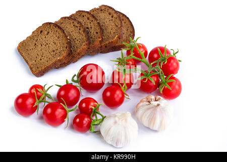 Zusammensetzung der schwarzen Scheiben Brot, Bündel von Tomaten und Knoblauch Stockfoto