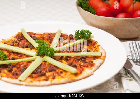 Türkisches Rindfleisch Pizza mit Gurke obenauf Stockfoto