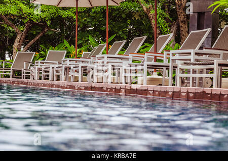 Bequeme Stühle in der Nähe von Hotel Pool Stockfoto