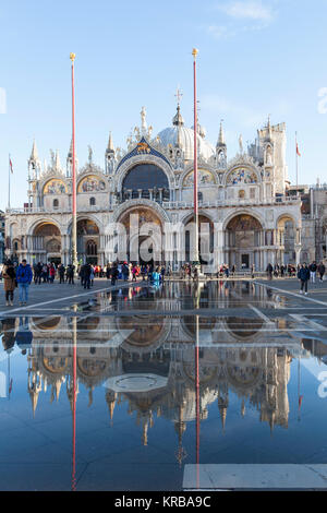 Basilika San Marco in Acqua Alta, oder außergewöhnliche High Tide, Piazza San Marco, Venedig, Italien mit Touristen an einem sonnigen Tag wider Stockfoto