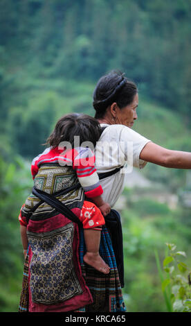 Ha Giang, Vietnam - May 19, 2013. Ein Hmong Frau mit Ihrem Kind auf Berg in Ha Giang, Vietnam. Viele Menschen in Ha Giang gehören zu einer der Vietnam ethn Stockfoto