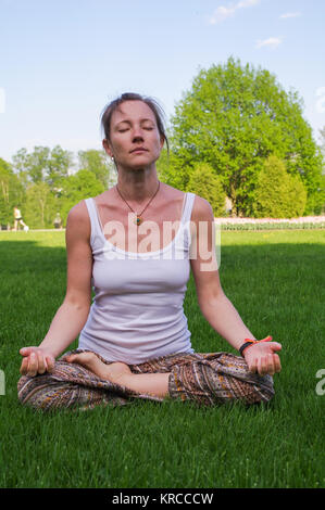 Junge Frau in Yoga sitting pose Meditation im Freien Stockfoto