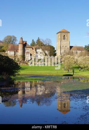 Little Malvern Court und Priory, Little Malvern, in der Nähe von Malvern, Worcestershire, mit Blick über einen Wasserabschnitt. Die unter die Kategorie I fallende Priory-Kirche (rechts) war einst ein Benediktinerkloster, von dem einige aus dem 12. Jahrhundert stammen. Das Haus (links), bekannt als Little Malvern Court, ist gelegentlich für die Öffentlichkeit zugänglich. Stockfoto