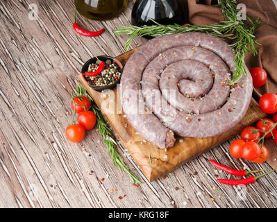 Rohes Rindfleisch Wurst mit Rosmarin und Gewürze auf einem Holztisch, Südafrikanische boerewors Stockfoto
