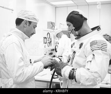 Techniker John Bolan Anzüge Apollo 9 Befehl Modul Pilot David R. Scott vor dem geplanten Start in die Erdumlaufbahn mit Commander James A. McDivitt und Lunar Module Pilot Russell L. Schweickart Stockfoto