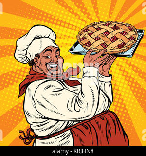 African American oder Latino Koch mit einem Beeren-Kuchen Stockfoto