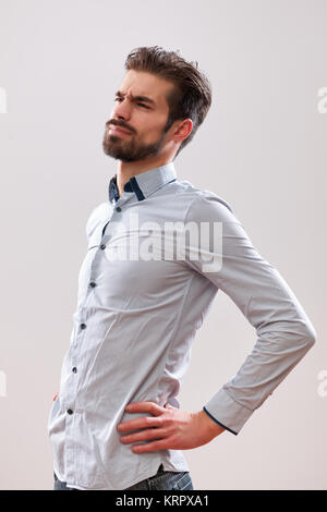 Porträt der jungen Geschäftsmann, ist Schmerz in seinem Rücken. Stockfoto