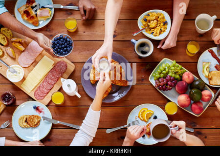 Personen mit Frühstück in der Tabelle mit Nahrungsmitteln Stockfoto