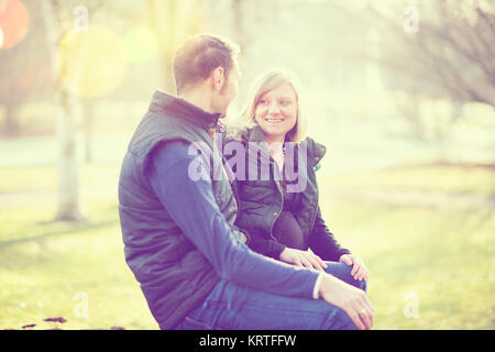 Der Mensch und seine schwangere Frau im Park Stockfoto