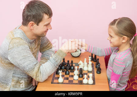 Vater und Tochter schüttelte Hände, ein Spiel des Schachs Stockfoto