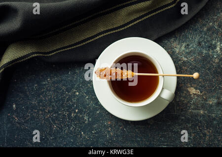 Braun gelb Zucker Kristall auf Holzstab und Kaffee Tasse. Stockfoto