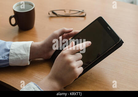 Weibliche Hände und eine Tablette Stockfoto