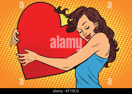 Schöne junge Frau umarmt Valentine Herz Stockfoto