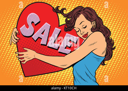 Schöne junge Frau umarmt Verkauf Valentine Herz Stockfoto