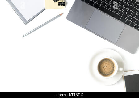 Schreibtisch mit Laptop, Kaffee, Notebook und Smartphone auf weißem Hintergrund. Ansicht von oben mit der Kopie. Stockfoto