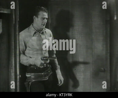 Noch aus dem 1934 erschienenen Film Blue Steel, in dem John Wayne als US-Marshal gegen Gesetzlose im amerikanischen Westen kämpft. Stockfoto