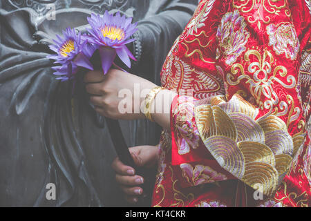 Frau Hand in Bezug auf Buddha-Statue. Stockfoto