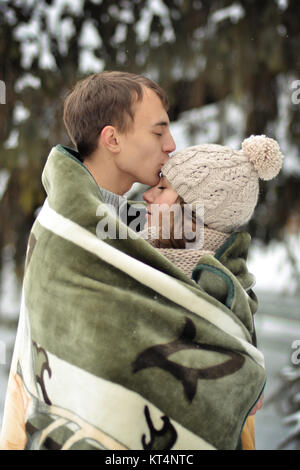 Schöner mann Kuss auf die Stirn, ihren Geliebten, schön, hübsch, attraktives Mädchen mit dem Pullover, Handschuhe, Winter, Kälte, Schnee, Wald, Hütte, Liebe, Zweisamkeit, glücklich, Paar, Lucky, zusammen, zwei, Jungen, Familie, Romantik, romantisch, Datum, dating. Stockfoto